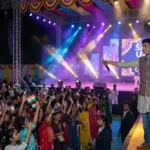 A confident student anchor delivering an energetic anchoring script in Hindi for a cultural event on stage.